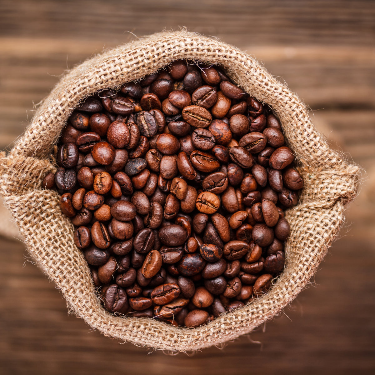 Organic fair trade coffee beans in a burlap sack, roasted to perfection. A key ingredient in JostArriba mushroom coffee, delivering natural energy, enhanced focus, and memory support without the jitters