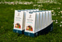 Wholesale pack of JostArriba brain boosting coffee boxes displayed on grass. A bulk mushroom coffee alternative with adaptogens and nootropics, ideal for retailers and distributors focused on brain health and mood support.